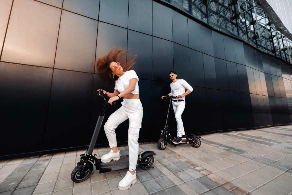 a girl and a guy are walking on electric scooters 2021 09 01 02 04 05 utc.jpg